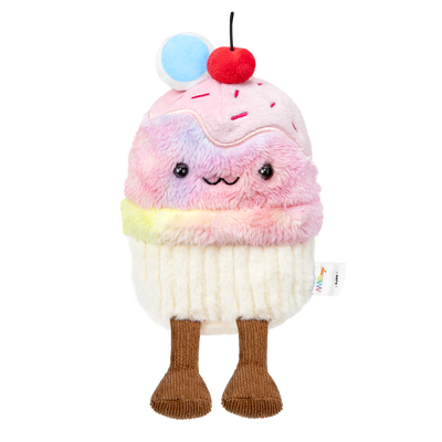 Plush toy resembling a cupcake with rainbow fur, cherry on top, and legs on a white background